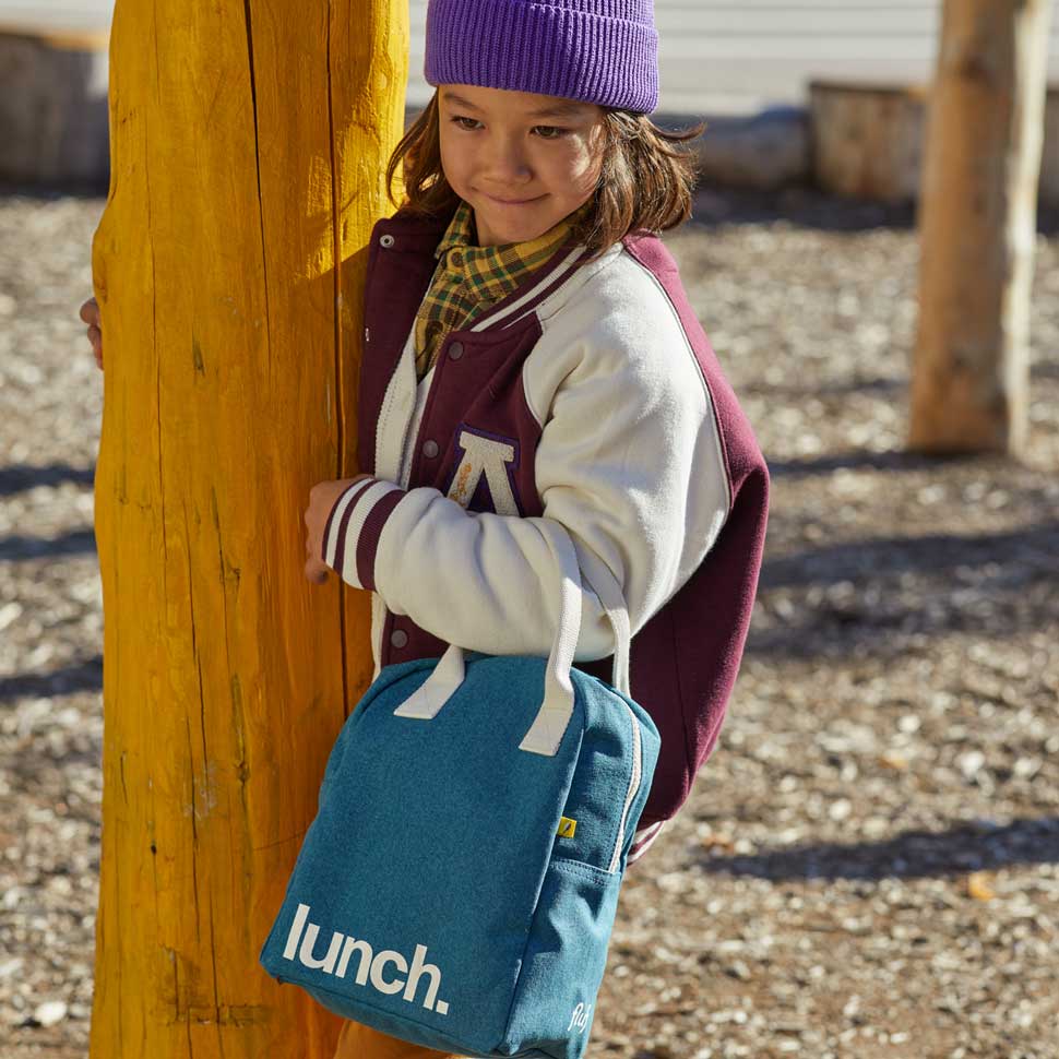 A boy holding Fluf's lunch bag