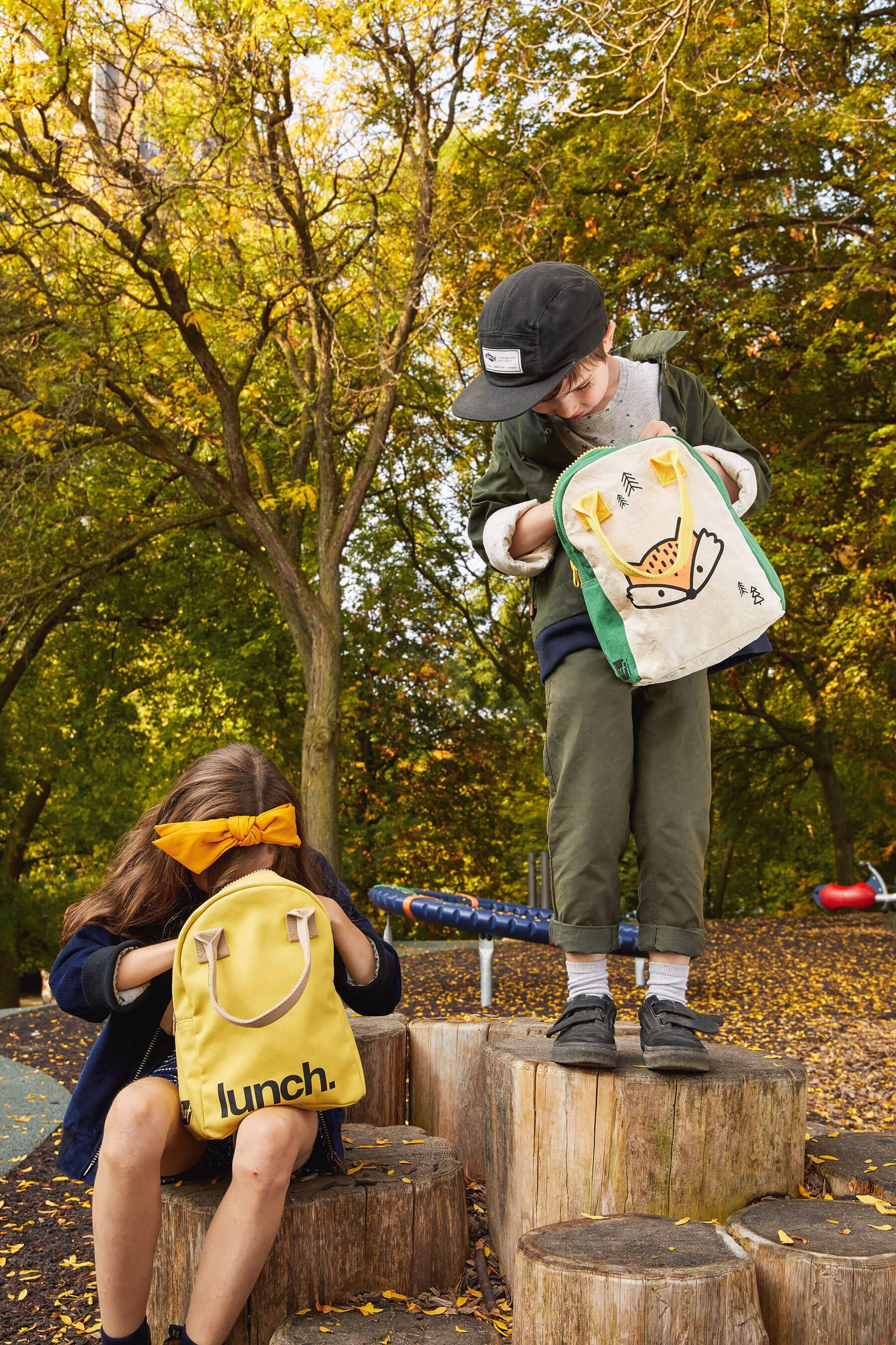 2 kids holding the yellow and the Fox Lunch Bag by fluf