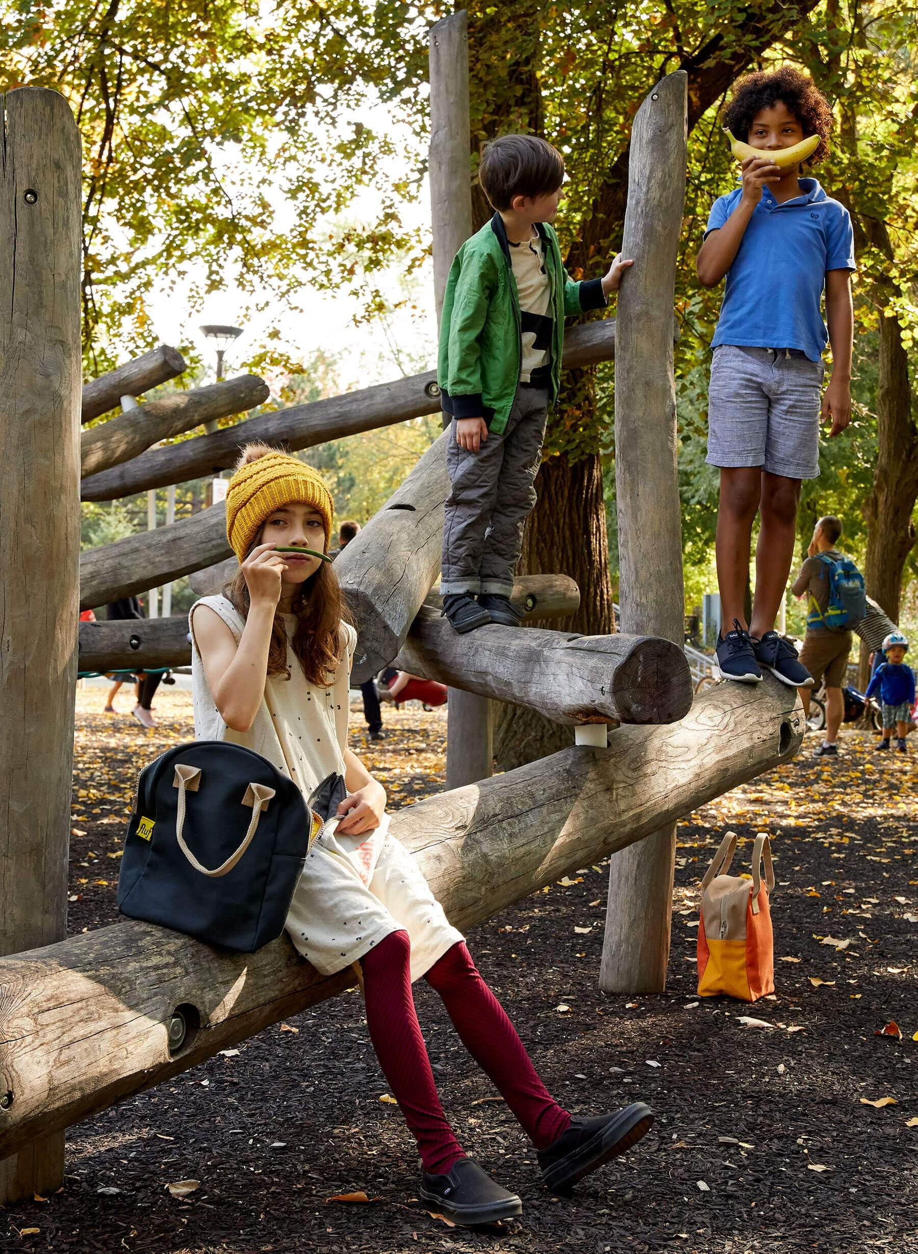 Kids playing in the park with Black Solid Lunch Bag