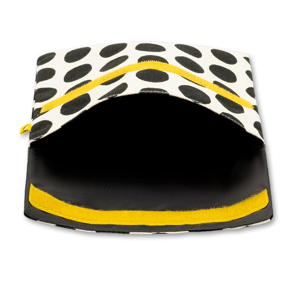 Open Reusable and machine washable snack bag in a sandwich size, with black and white dots design and yellow velcro. 