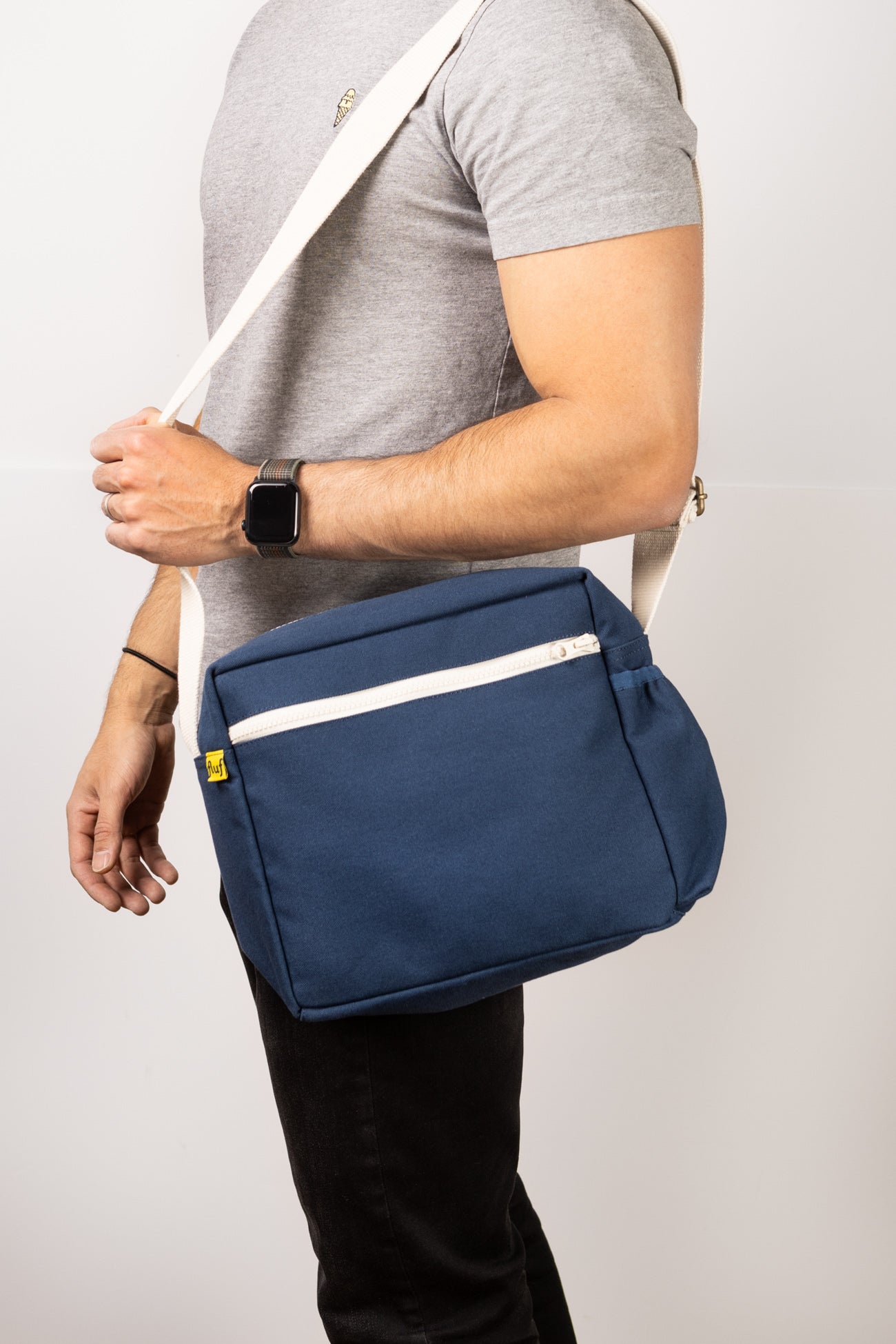 a man holding Fluf over the shoulder lunch bag box