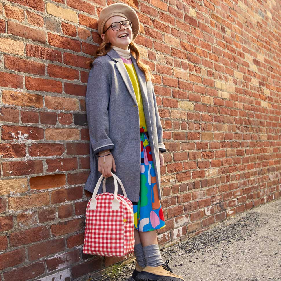 A woman holding a Gingham Red Zipper Lunch bag 